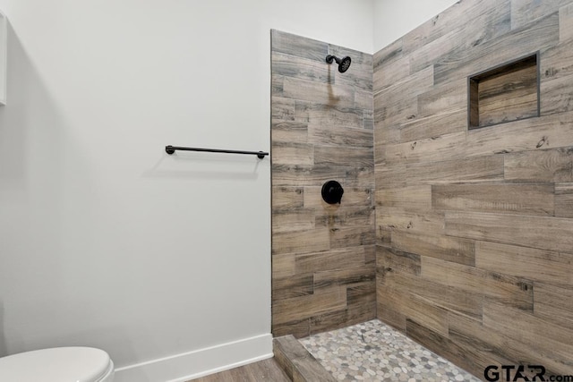 16330 Crossing Cir, Lindale, TX 75771 - bathroom with a tile shower and wood finished floors