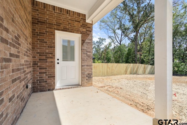 16330 Crossing Cir, Lindale, TX 75771 - doorway to property with brick siding and a patio