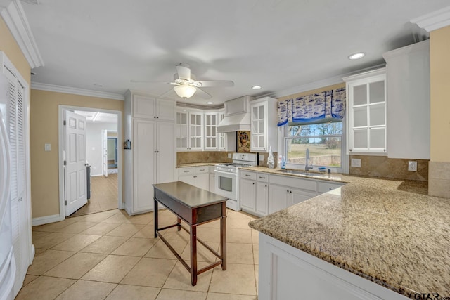 386 Fm 1711, Jacksonville, TX 75766 - kitchen featuring exhaust hood, a sink, ceiling fan, white range with gas cooktop, and decorative backsplash