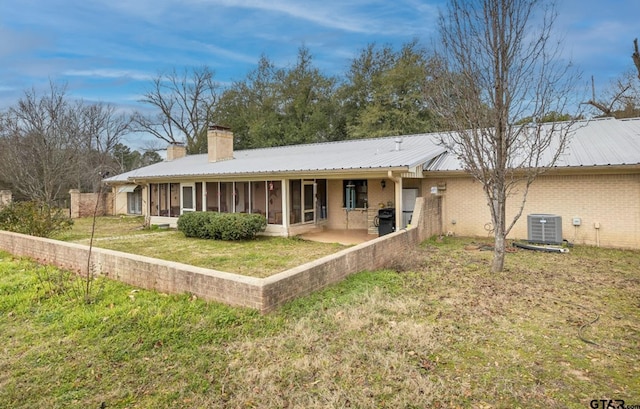 386 Fm 1711, Jacksonville, TX 75766 - rear view of house featuring a yard, cooling unit, metal roof, and a chimney