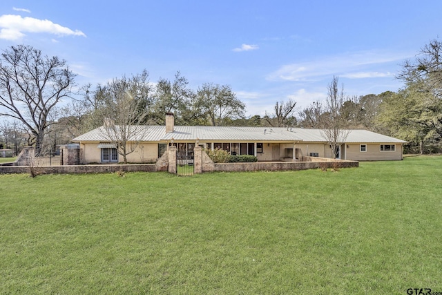 386 Fm 1711, Jacksonville, TX 75766 - back of house featuring a yard, metal roof, and a chimney