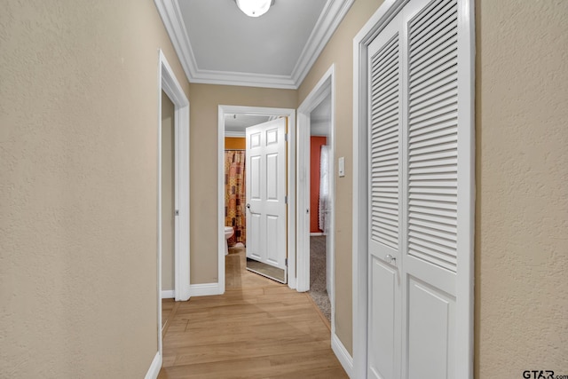 386 Fm 1711, Jacksonville, TX 75766 - hallway with a textured wall, baseboards, light wood-type flooring, and ornamental molding