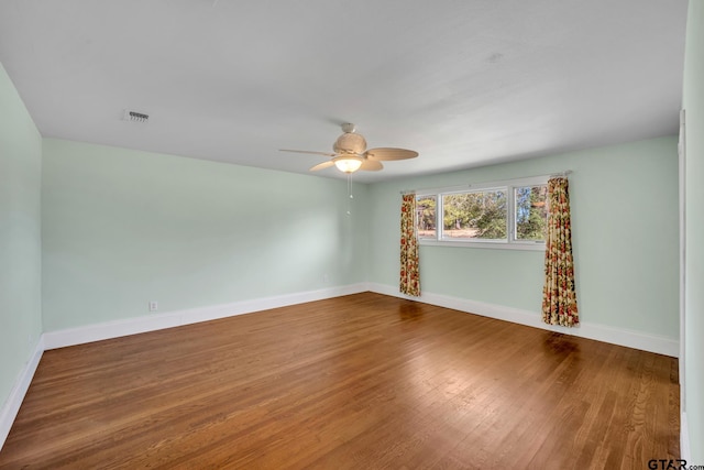 386 Fm 1711, Jacksonville, TX 75766 - empty room featuring visible vents, ceiling fan, baseboards, and wood finished floors