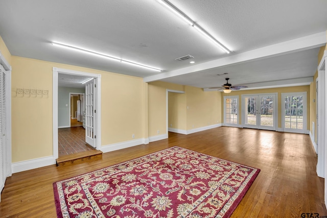 386 Fm 1711, Jacksonville, TX 75766 - empty room with baseboards, french doors, visible vents, ceiling fan, and wood finished floors