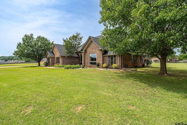301 Hines Xing, Bullard, TX 75757 - view of front of house with brick siding, a front yard, and roof with shingles