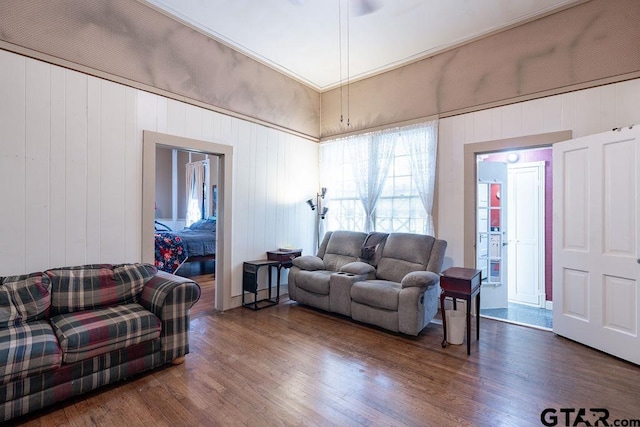 living room featuring wood walls and dark hardwood / wood-style floors