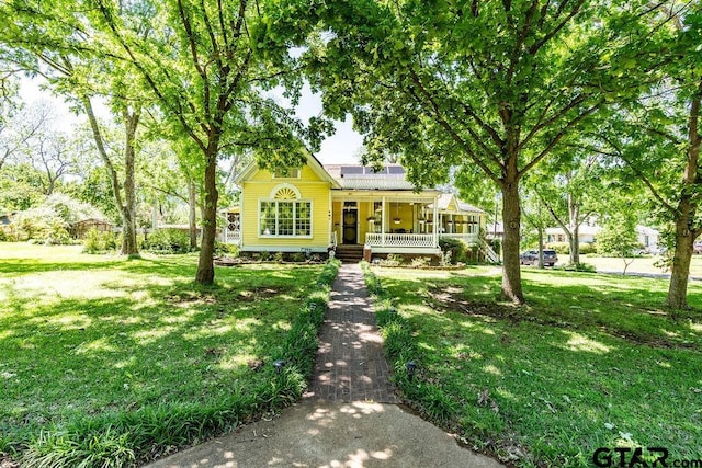 view of front of property with a front yard and covered porch