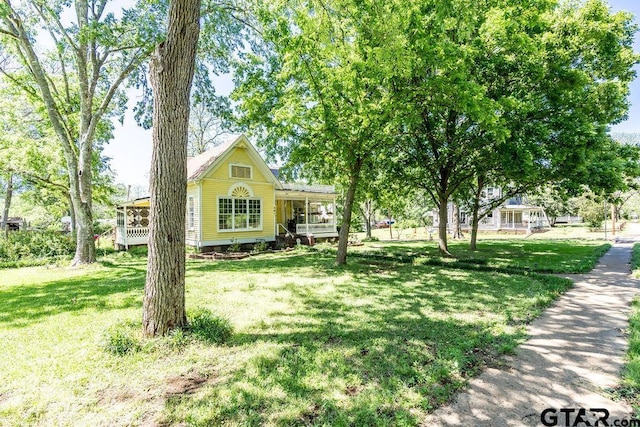 view of front of home with a porch and a front lawn