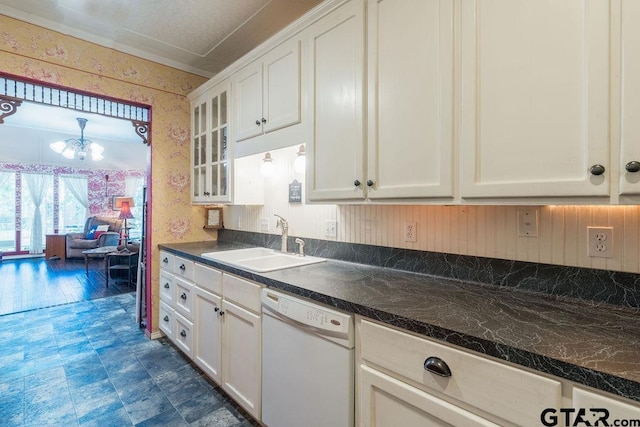 kitchen with white cabinets, sink, dishwasher, and a notable chandelier