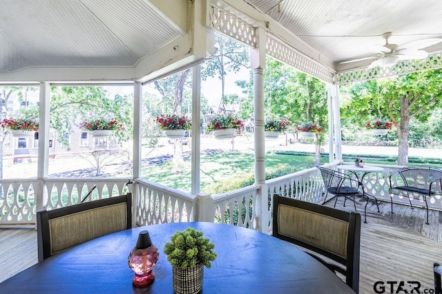 sunroom / solarium with lofted ceiling and ceiling fan