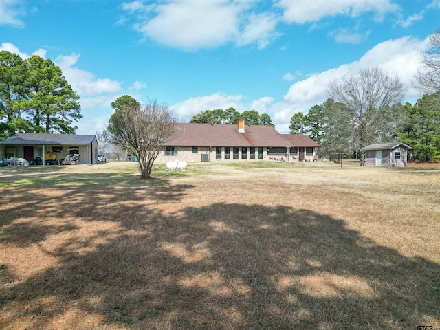 11790 E US Highway 175, Larue, TX 75770 - back of property featuring an outdoor structure, a lawn, and a chimney