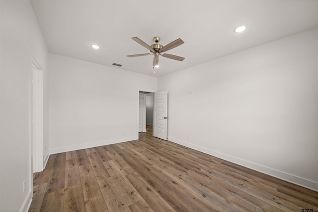 empty room with ceiling fan and wood-type flooring