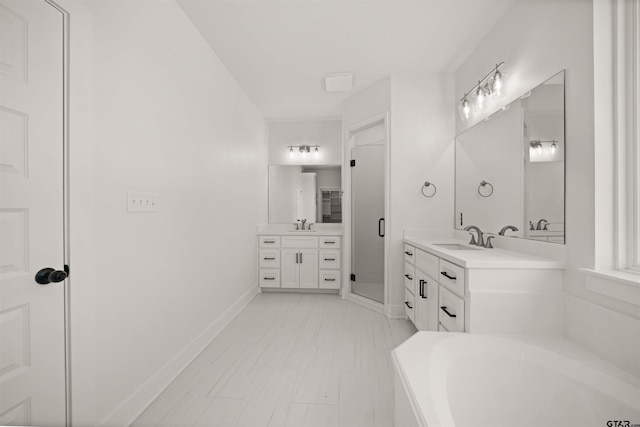 bathroom with vanity and independent shower and bath