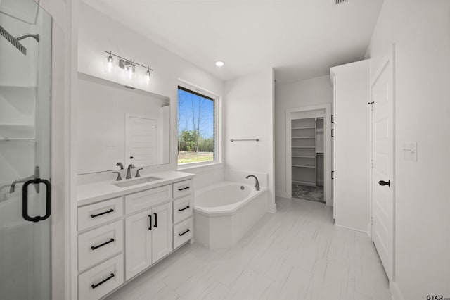 bathroom with separate shower and tub and vanity