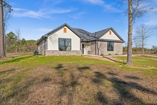 view of front of home featuring a front yard and central air condition unit