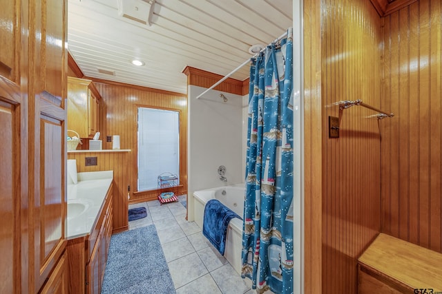 bathroom with vanity, tile patterned floors, wood walls, and shower / tub combo with curtain