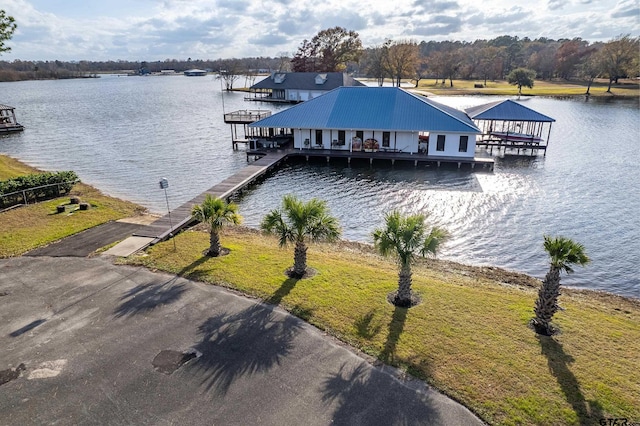 dock area with a yard and a water view