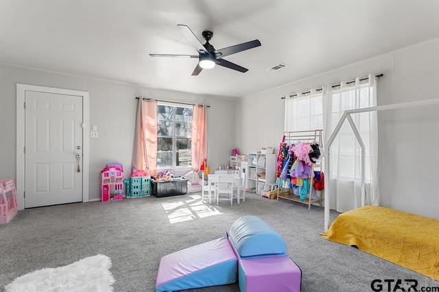 playroom featuring ceiling fan and carpet