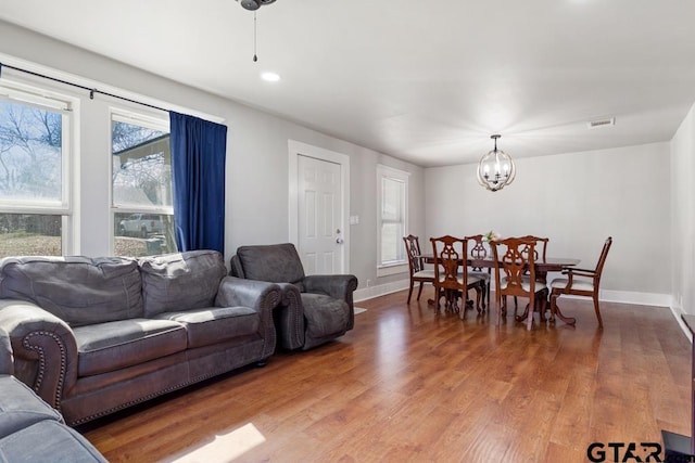 living room featuring hardwood / wood-style flooring and a notable chandelier