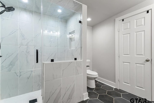 bathroom with toilet, tile patterned flooring, and a shower with shower door