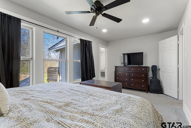 bedroom with ceiling fan and light colored carpet