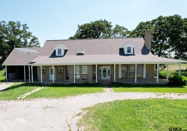 cape cod-style house featuring a front yard and a porch