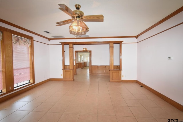 tiled spare room featuring crown molding and ceiling fan