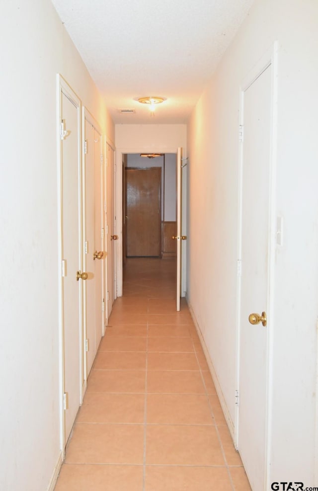 corridor featuring light tile patterned flooring