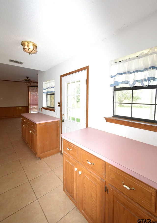 kitchen featuring a kitchen island and light tile patterned flooring