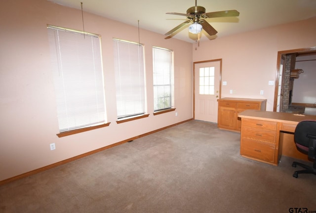 unfurnished office featuring ceiling fan and light colored carpet