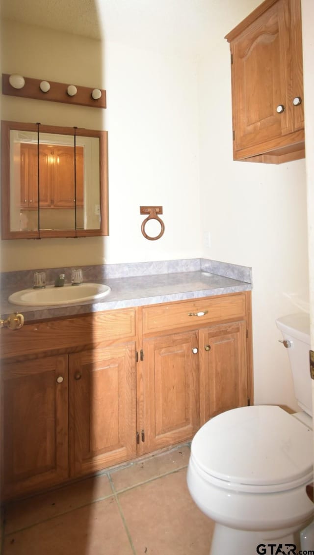 bathroom featuring tile patterned floors, toilet, and vanity