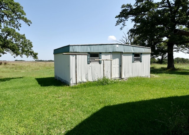 view of outbuilding with a yard