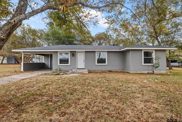 ranch-style home with a front lawn and a carport