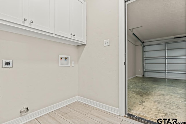 washroom with cabinets, electric dryer hookup, and washer hookup