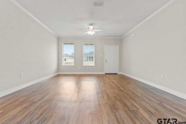 empty room with crown molding, ceiling fan, and hardwood / wood-style flooring