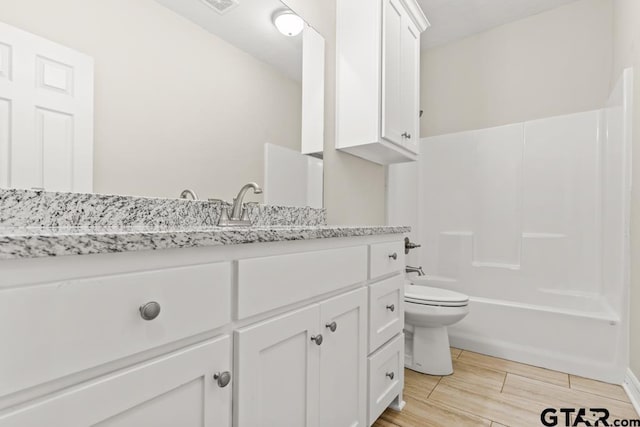 full bathroom with vanity, tub / shower combination, and toilet