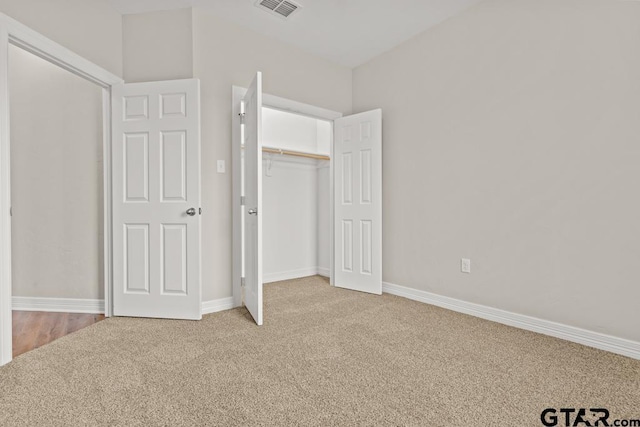 unfurnished bedroom with carpet floors and a closet