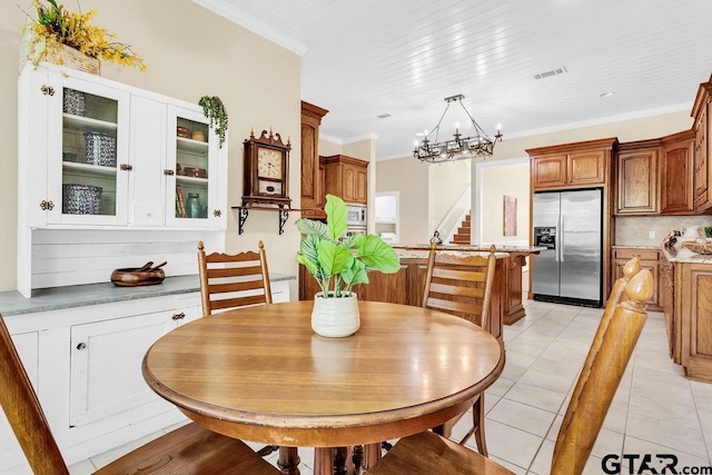 dining room with visible vents, crown molding, stairs, an inviting chandelier, and light tile patterned flooring