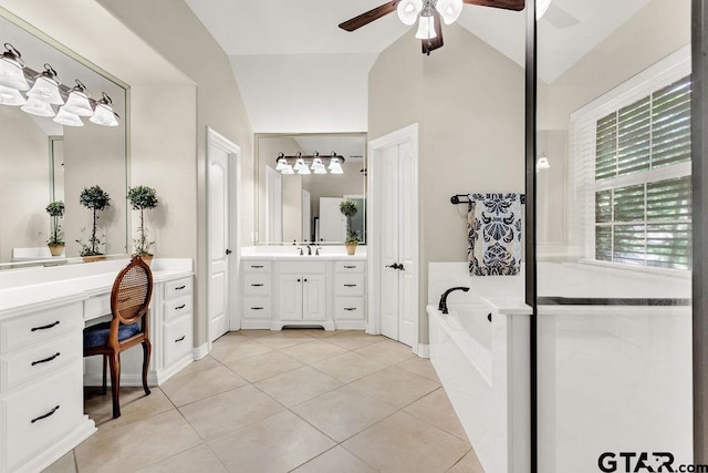 bathroom featuring ceiling fan, a garden tub, vanity, tile patterned floors, and lofted ceiling