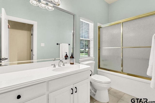 bathroom with shower / bath combination with glass door, tile patterned floors, toilet, and vanity