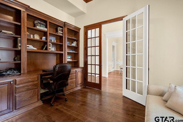 office with dark wood finished floors, french doors, and built in study area