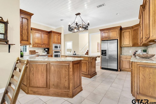 kitchen featuring a peninsula, light stone countertops, and appliances with stainless steel finishes