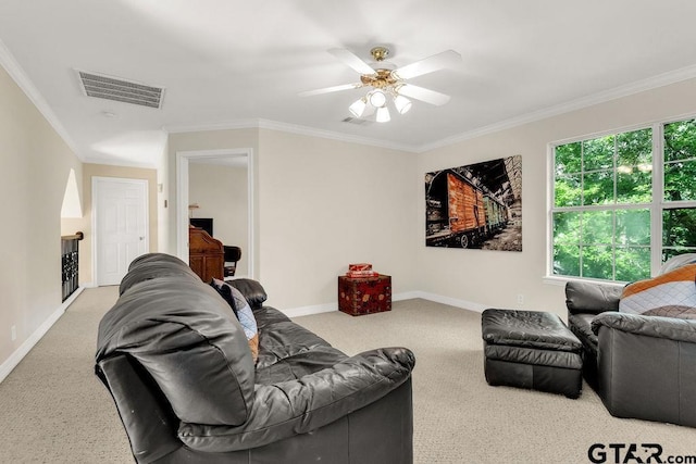 living area featuring ceiling fan, visible vents, crown molding, baseboards, and carpet flooring
