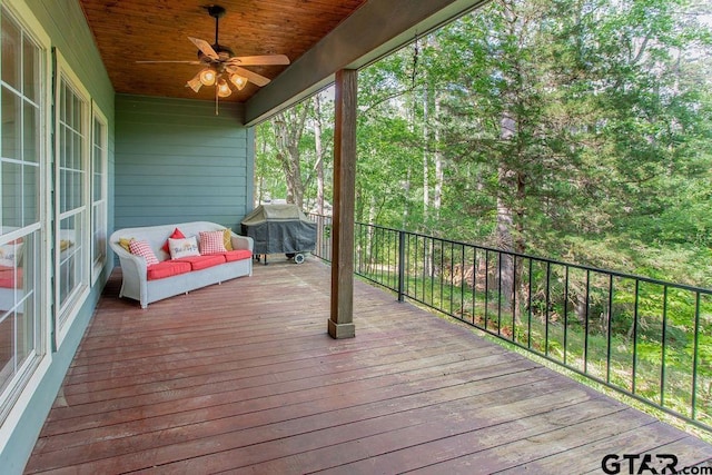deck featuring a ceiling fan and a grill