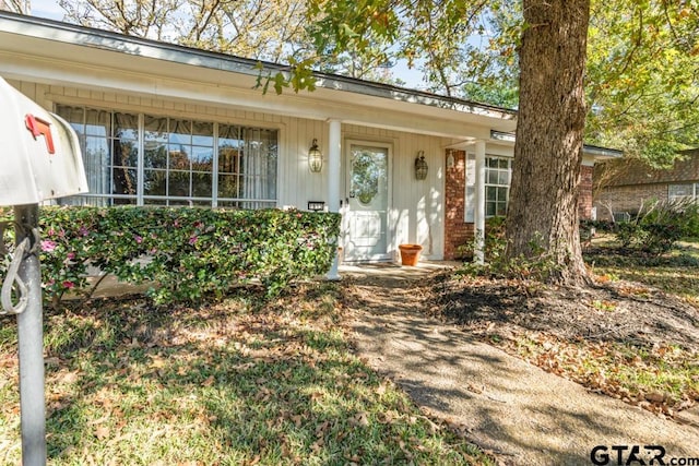 doorway to property featuring a porch