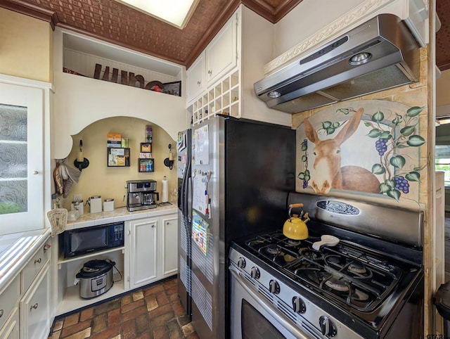 601 Troup Hwy, Tyler, TX 75701 - kitchen featuring exhaust hood, tile countertops, brick floors, white cabinets, and black microwave