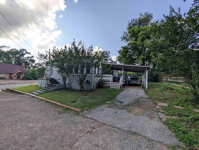 601 Troup Hwy, Tyler, TX 75701 - view of front of house featuring driveway and a carport