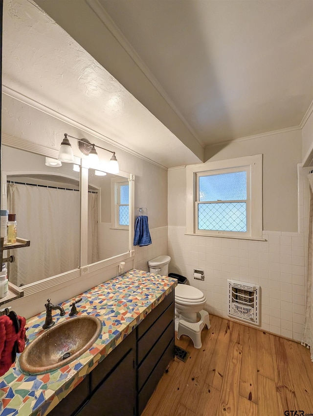 601 Troup Hwy, Tyler, TX 75701 - bathroom with heating unit, tile walls, toilet, healthy amount of natural light, and hardwood / wood-style flooring