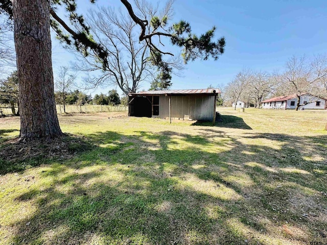 view of yard with an outbuilding and a pole building