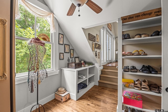 entryway with lofted ceiling, ceiling fan, and light hardwood / wood-style flooring